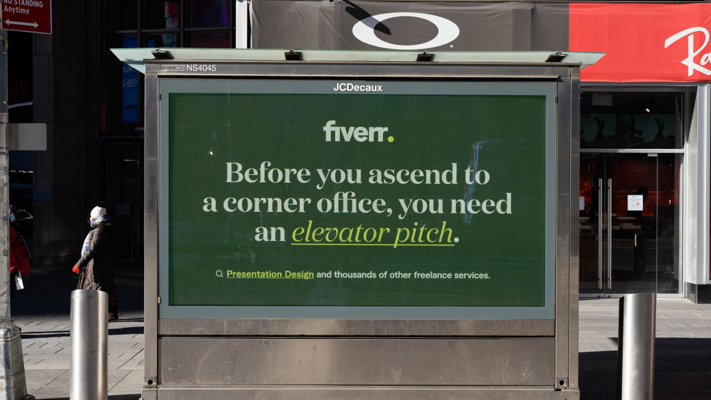 Roof-line green billboard on brick: Before you drop the mic you need a voice to make your ad sing—Voice Over search CTA under clear sky